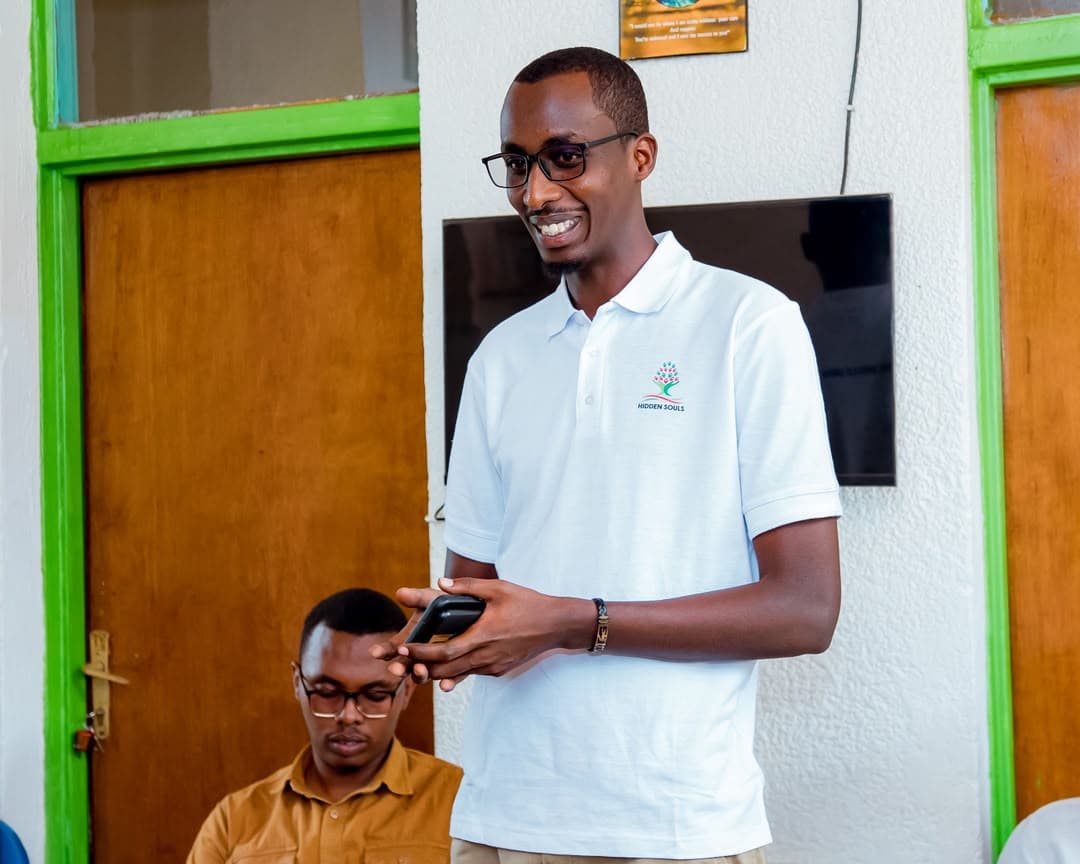A Hidden Souls volunteer standing with elders at home